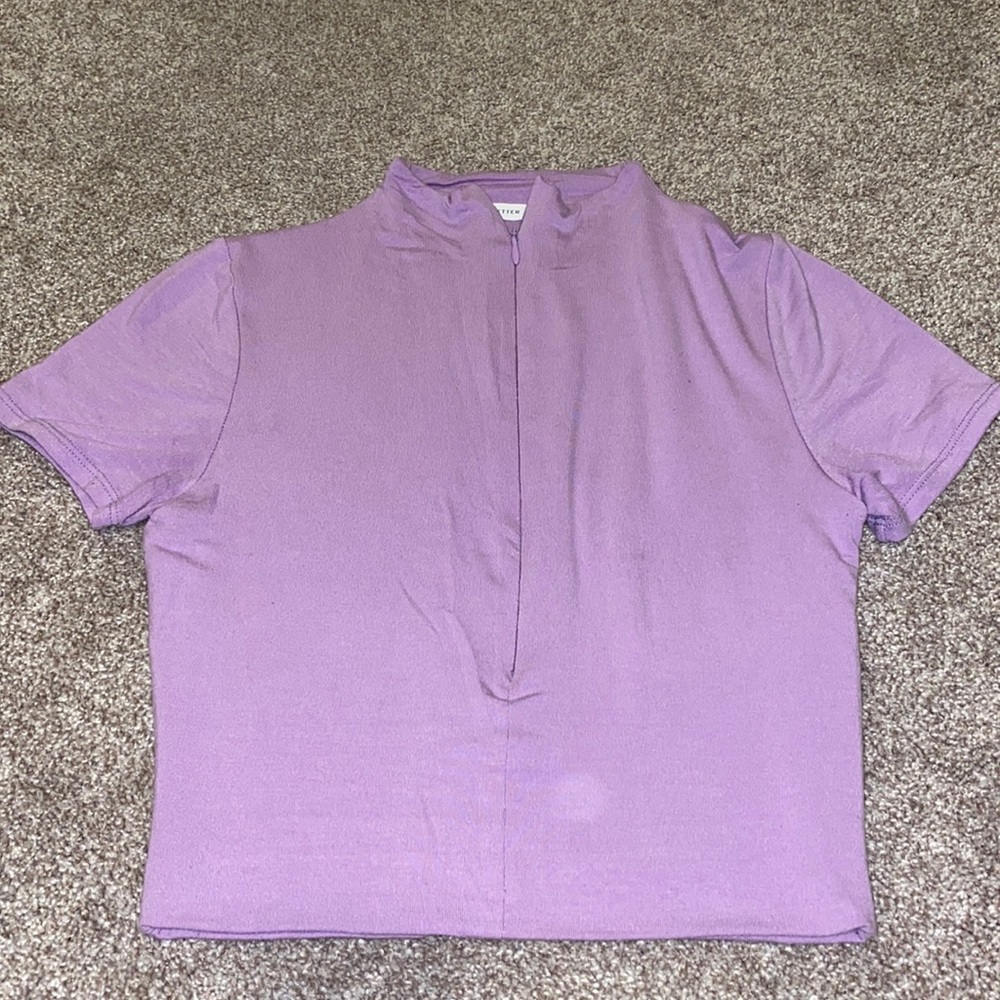 Purple cropped top has a zipper on the front